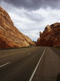 Empty road with mountains in background