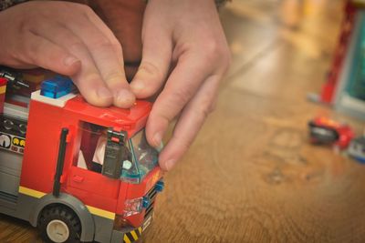 High angle view of hand holding toy