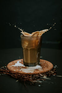 Close-up of coffee splashing in glass