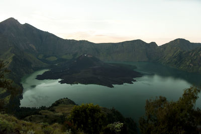 Scenic view of lake and mountains against sky