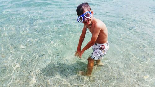 Portrait of shirtless boy in sea