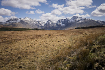 Scenic view of mountains against cloudy sky