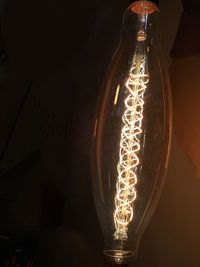 Close-up of illuminated lamp at night