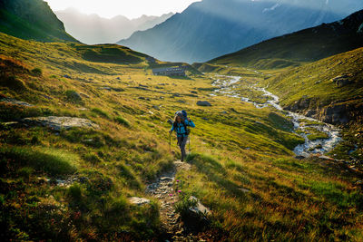 Full length of woman hiking on mountain