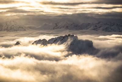 Scenic view of majestic mountains against sky during sunset