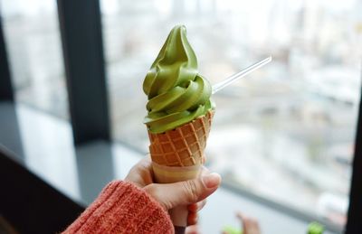 Close-up of hand holding ice cream