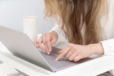 Midsection of woman using mobile phone