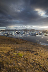 Scenic view of sea against storm clouds