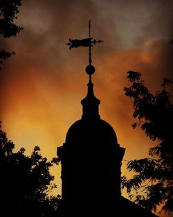 Low angle view of silhouette tree against cloudy sky during sunset