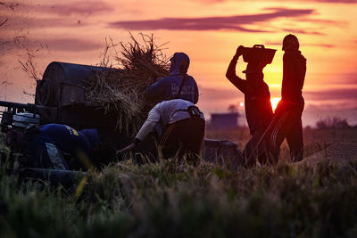 Rear view of silhouette people on field