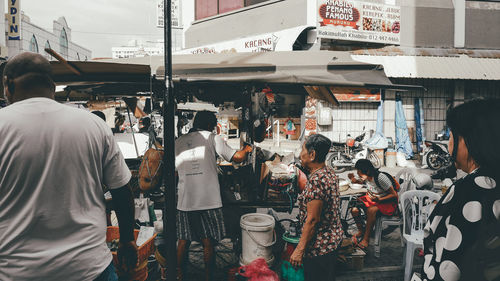 People at market stall in city