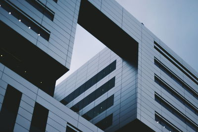 Low angle view of office building against clear sky