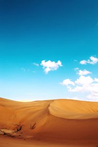 Scenic view of desert against blue sky