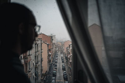 Low angle view of buildings seen through glass window