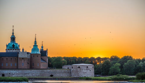 Historic building against sky during sunset