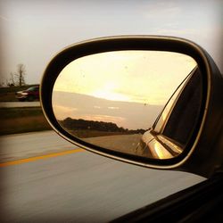 Reflection of sky in side-view mirror