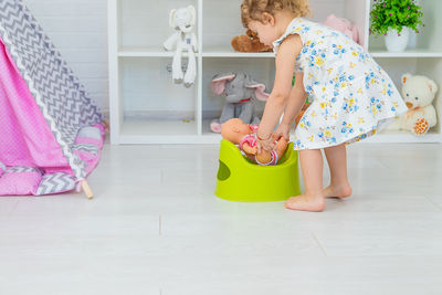 High angle view of girl playing with toy on table