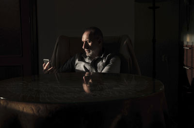 Portrait of young man sitting at home