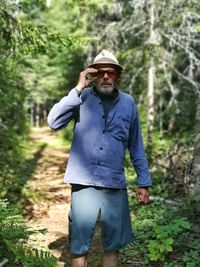 Full length of man standing against trees