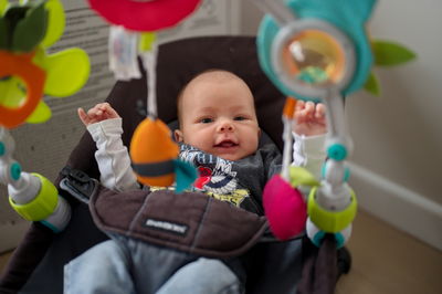 Midsection of boy playing with toys