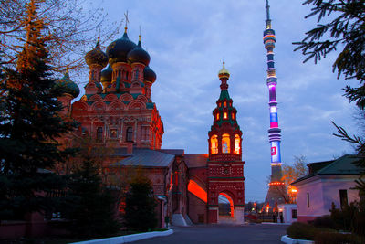 Low angle view of illuminated buildings against sky