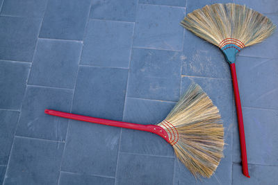 High angle view of brooms on tiled floor