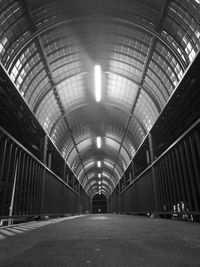 Empty corridor along illuminated lights