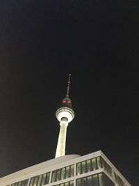 Low angle view of communications tower against sky