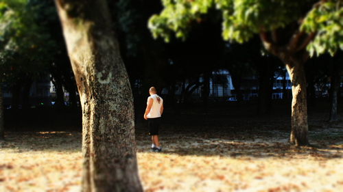 Full length of man walking on tree trunk