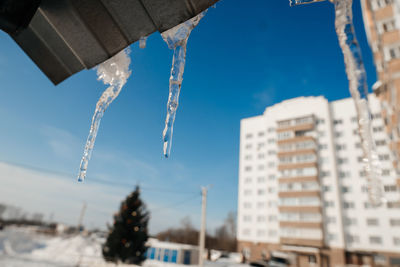 Icicles melt on the roof in spring