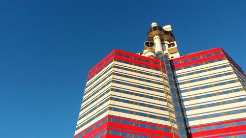 Low angle view of building against clear blue sky