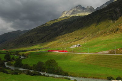 Scenic view of green landscape against sky