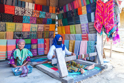 Full length of people working in traditional clothing