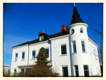 Low angle view of building against clear blue sky