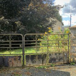 Fence by railing against sky