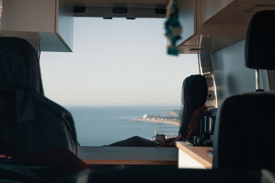 Rear view of woman sitting in bus