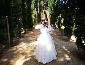 Girl holding camera outdoors