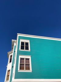 Low angle view of building against blue sky