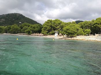 Scenic view of swimming pool by sea against sky