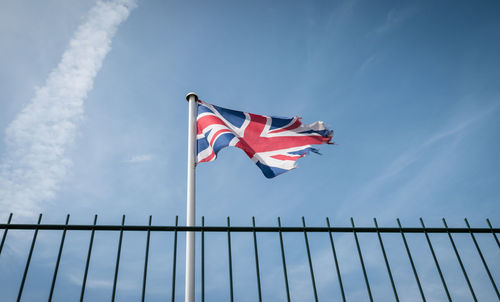 Low angle view of british flag waving against sky