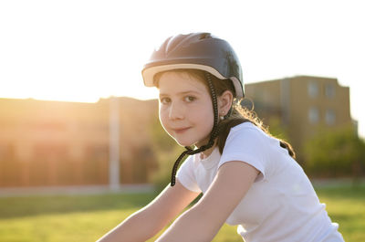 Portrait of young woman standing on playing field