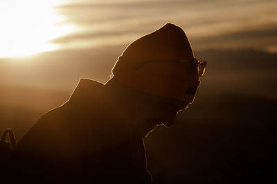 Low angle view of silhouette woman against sky during sunset