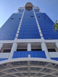 Low angle view of modern building against clear blue sky