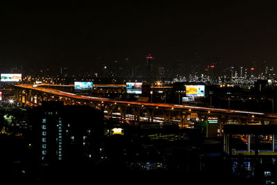 High angle view of illuminated buildings in city at night