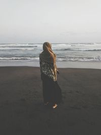 Rear view of woman looking at sea against sky