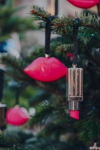 Pink lips and lipstick decorations on a christmas tree.