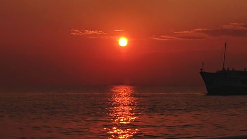 Scenic view of sea against orange sky