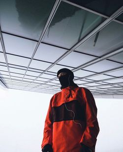 Low angle view of man standing against sky