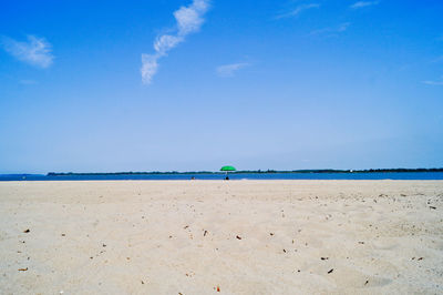 Scenic view of beach against blue sky