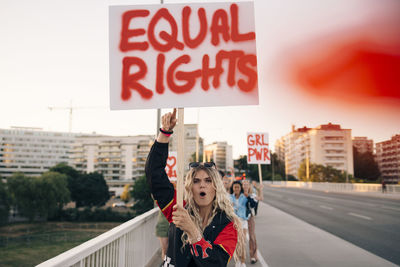 Full length of woman standing in city against sky